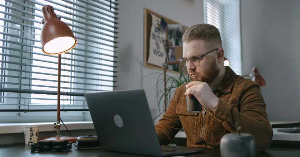 young adult online gambling on a laptop
