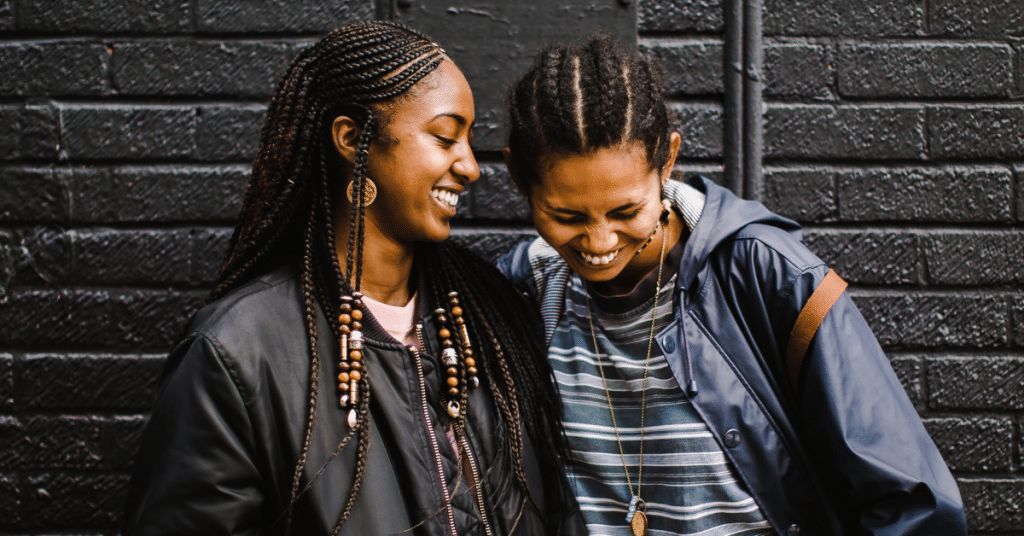 two people smiling, in a happy consensual non-monogamous partnership