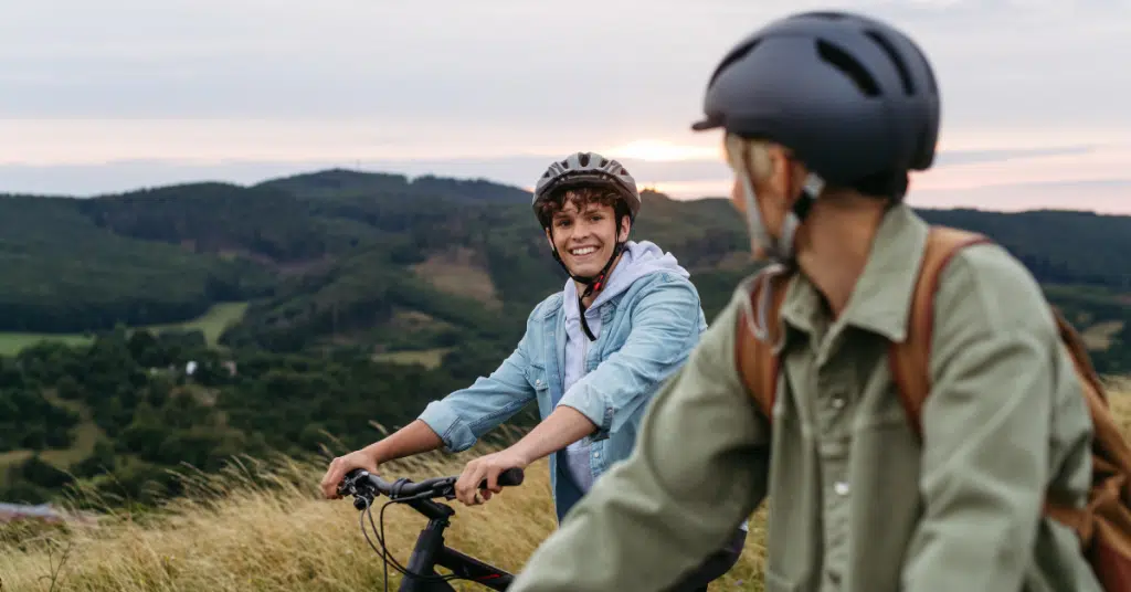 teen boy biking outside with parent to minimize screen time and reliance on devices