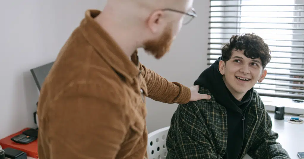 a parent supports his son who is anxious about a test