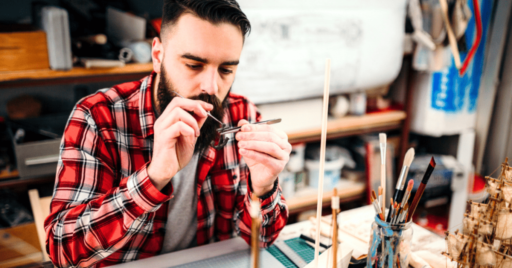a man concentrates on building a model which is his version of play