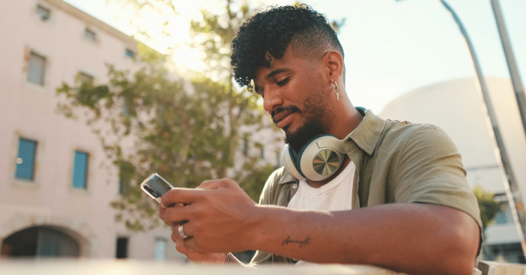 a man scrolls on phone and falls into social comparison