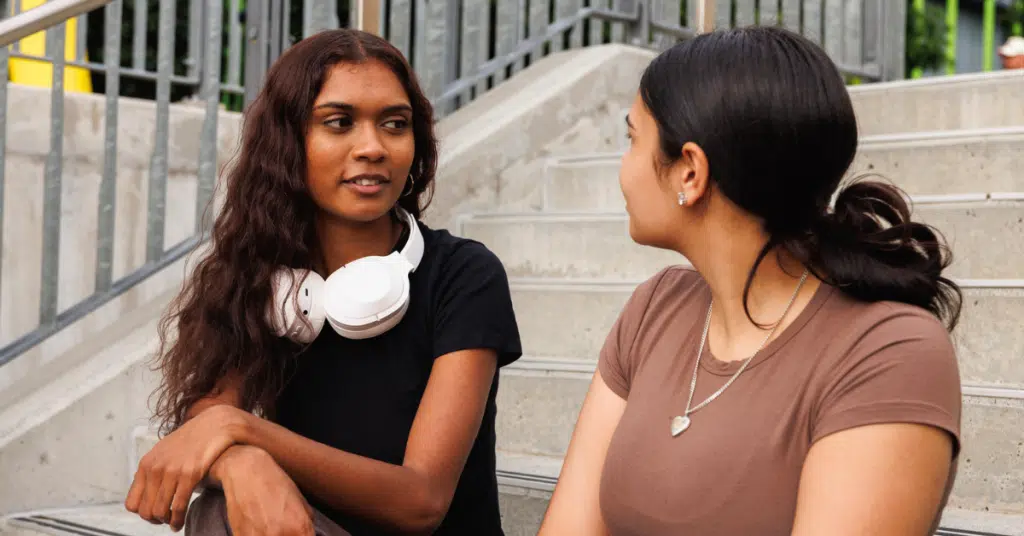 a young woman talking to her friend about a breakup