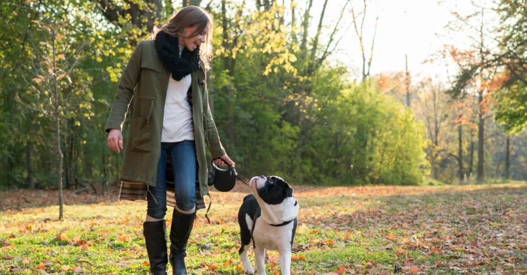 woman takes a break by going outside with dog